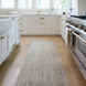 Surya Hope HOP-2300-P hand-loomed runner rug in neutral multi-tone recycled PET yarn, on a light wood kitchen floor.