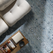 Hand-knotted Surya Almeria ALM2302 low pile area rug in multi-tone Denim, Black, Dusty Sage, and Cream.