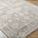 Surya Antalya AAT-2301 transitional wool area rug in beige with subtle floral patterns and fringe.