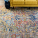 Hand-knotted Surya Cappadocia wool rug with intricate patterns in dusty sage, mauve, blue, mustard, and olive.