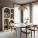 Ivory washed mango wood Surya Tana Bookcase with global-inspired bohemian design and varied arched/rectangular shelves.