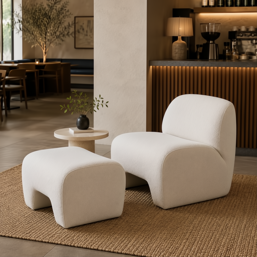 Ivory Surya Sable accent chair and ottoman with foam construction on a woven rug.