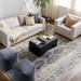 Surya Neemrana black brushed acacia wood coffee table with exposed grain in a modern living room.