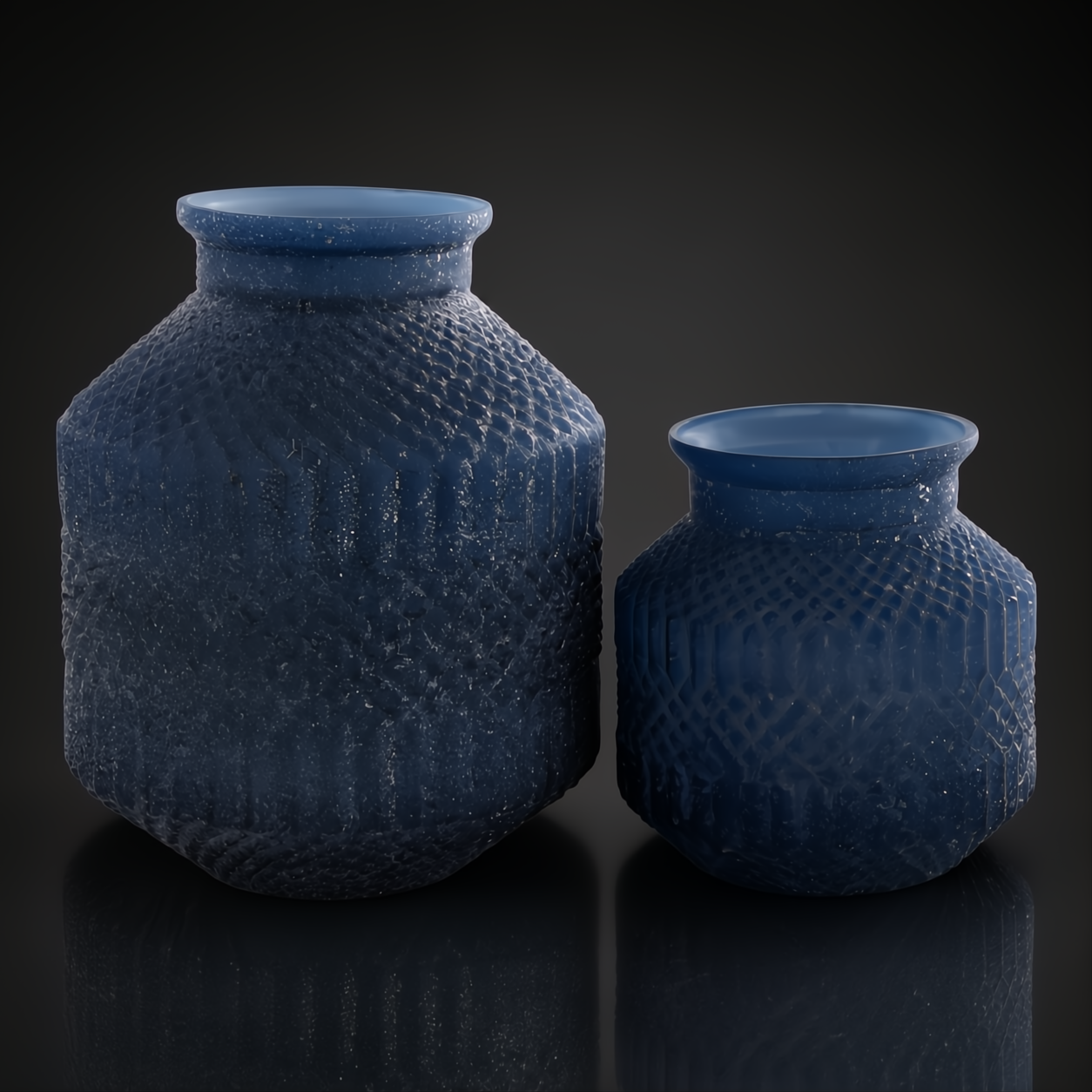 Two blue marbled glass decorative accents with sculptural, textured designs.