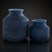 Two blue marbled glass decorative accents with sculptural, textured designs.