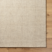Surya Aiden AEN-1000 hand-tufted wool area rug in Tan and Ivory, medium pile, on wood floor.