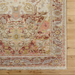 Surya Cappadocia wool rug with traditional plum, gray, burgundy, and olive pattern on light background, fringed edge.