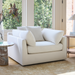 Surya Capitola white upholstered accent chair with three pillows, a clean, relaxed design.