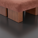 Surya Mirava Ottoman with a plush, rust-colored polyester cover and sturdy wooden block legs.