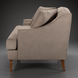 Surya Maywood accent chair with light brown polyester upholstery, dark brown rubber wood base, and two pillows.