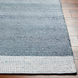 Hand-woven Surya Abby ABB-2302 area rug in blue and white recycled PET yarn on a wood floor.