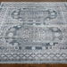 Surya Almeria low pile area rug with intricate geometric patterns in black, gray, beige, and blue.