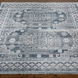 Surya Almeria low pile area rug with intricate geometric patterns in black, gray, beige, and blue.
