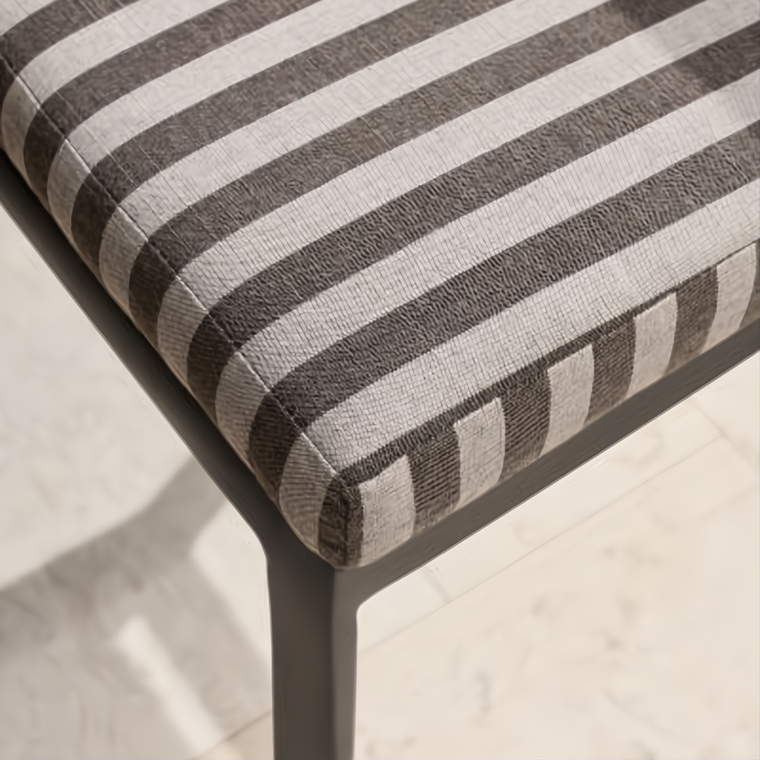 Surya Antibes dining chair with multi-color striped Sunbrella acrylic cushion and black powder-coated aluminum base.