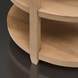 Close-up of the Surya Rosemary console table's light mango wood base and curved lower shelf.