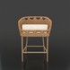 Surya Marvella counter stool with woven brown rattan back, light cushion, and light brown aluminum legs.