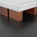 Surya Mirava Ottoman with a checkered polyester cover, rounded square shape, and brown stained rubber wood base.