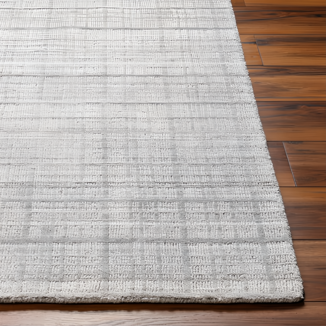 Surya Fresno FNO2302 hand-loomed area rug in multi-tone gray recycled PET yarn, on wood floor.