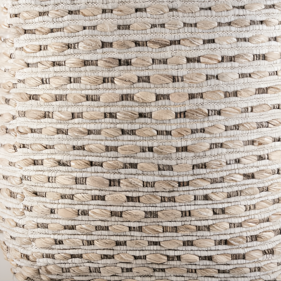 Close-up of a Surya Lanier Pouf, showing its natural woven wool texture with light and dark horizontal stitching.