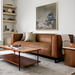Modern Surya Dylan sofa in rich brown top-grain leather with a black metal base, styled in a living room.
