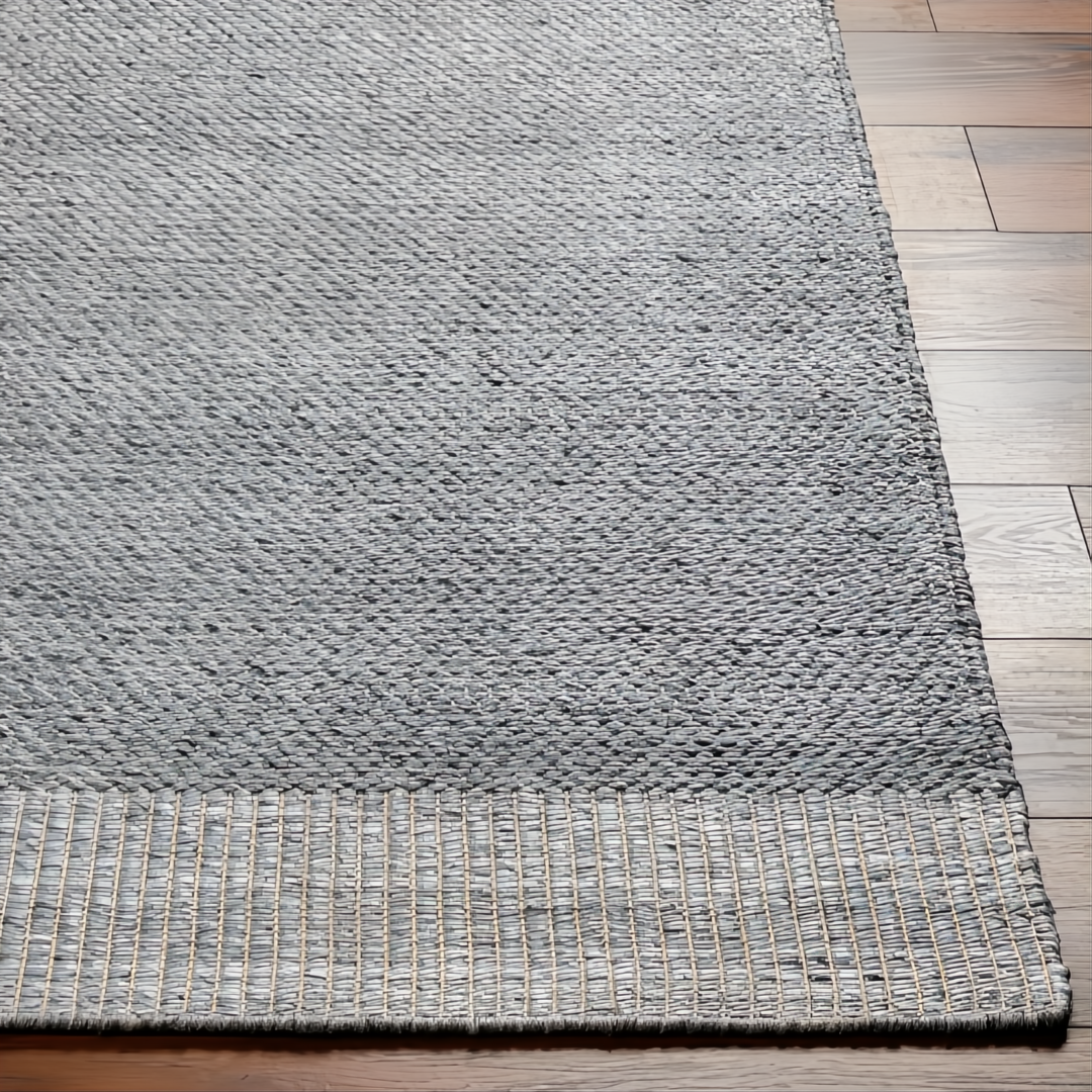 Gray hand-woven Surya Abby ABB-2300 area rug made from recycled PET yarn on a wood floor.