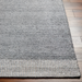 Gray hand-woven Surya Abby ABB-2300 area rug made from recycled PET yarn on a wood floor.