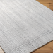 Surya Hope HOP-2303-P hand-loomed flatwoven area rug in white, gray, and light slate recycled PET yarn.