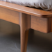 Close-up of Grande King/CA King wood bed, showing its brown poplar construction and minimalist design.