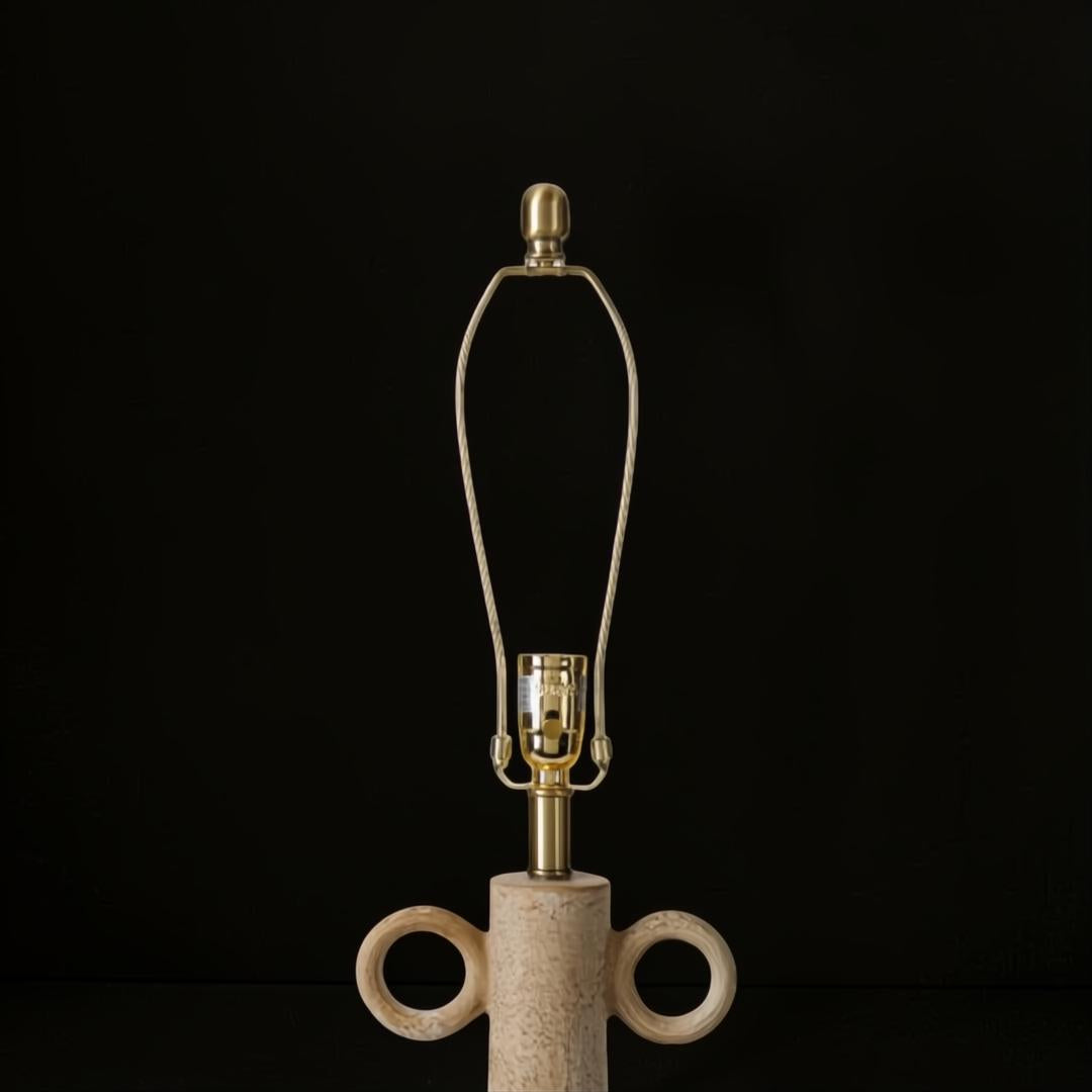Surya Brava accent table lamp with a textured beige base, gold metal hardware, and an E-26 socket.