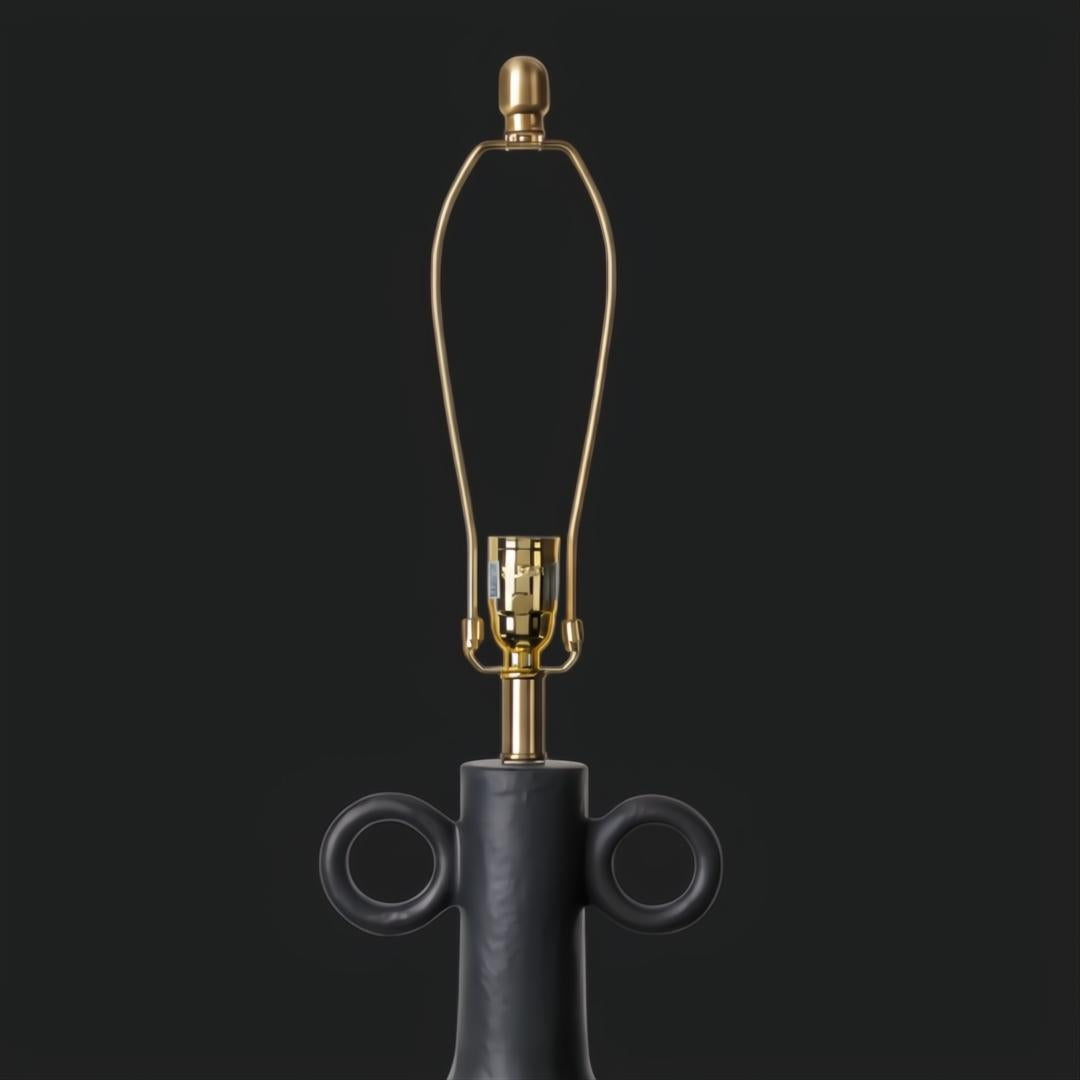 Traditional black ceramic accent table lamp base with gold harp and finial.