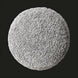 Round Surya Mohave pouf with textured light gray polyester top and soft cotton base.