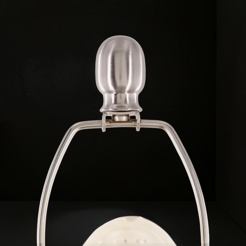 Close-up of a Surya Bentley accent table lamp's brushed metal finial and harp, showcasing its sleek, modern design.