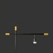 Modern black and gold sculptural floor lamp with exposed bulb socket.