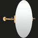 Oval wall mirror with a sleek, adjustable brass arm and mounting hardware, ideal for modern spaces.