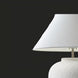 Surya Arion accent table lamp with a white linen shade and a textured, glazed cream ceramic base.