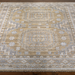 Hand-knotted Surya Almeria rug with mustard, gray, and blue geometric patterns on a low pile.