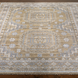 Hand-knotted Surya Almeria rug with mustard, gray, and blue geometric patterns on a low pile.
