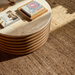 Surya Redondo coffee table with a beige polished marble top and ribbed beige lacquered mango wood base.