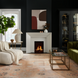 Surya Capelli accent table lamp with a white ceramic base and fabric shade in a dark living room.
