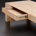 Surya Coburn minimalist modern brown mango wood coffee table with an open drawer.