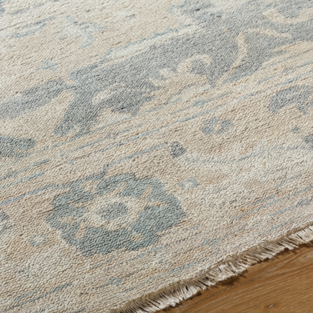 Hand-knotted Surya Cappadocia wool rug with light beige and muted blue traditional pattern, fringe detail.