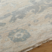 Hand-knotted Surya Cappadocia wool rug with light beige and muted blue traditional pattern, fringe detail.