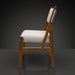 Surya Bergene dining chair with light beige upholstery and a brown natural rubber wood frame.