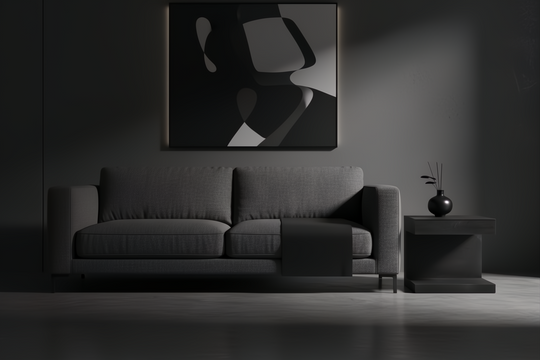 Surya Coburn black mango wood end table next to a gray sofa in a minimalist room.