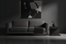 Surya Coburn black mango wood end table next to a gray sofa in a minimalist room.
