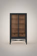 Tall black and brown Marin bookcase with glass sliding doors, adjustable shelves, and two soft-close drawers.