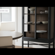 Black and brown Surya Marin Bookcase with glass doors, adjustable shelves, and displayed dishware.