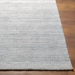 Surya Hickory HCK2302 hand-loomed rug in light beige, gray, and charcoal recycled PET yarn with a textured low pile.