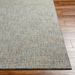 Surya Aiden AEN-1001 hand-tufted wool area rug in light blue and cream, on a wooden floor.