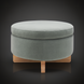Round green upholstered storage ottoman with a light brown rubber wood base.